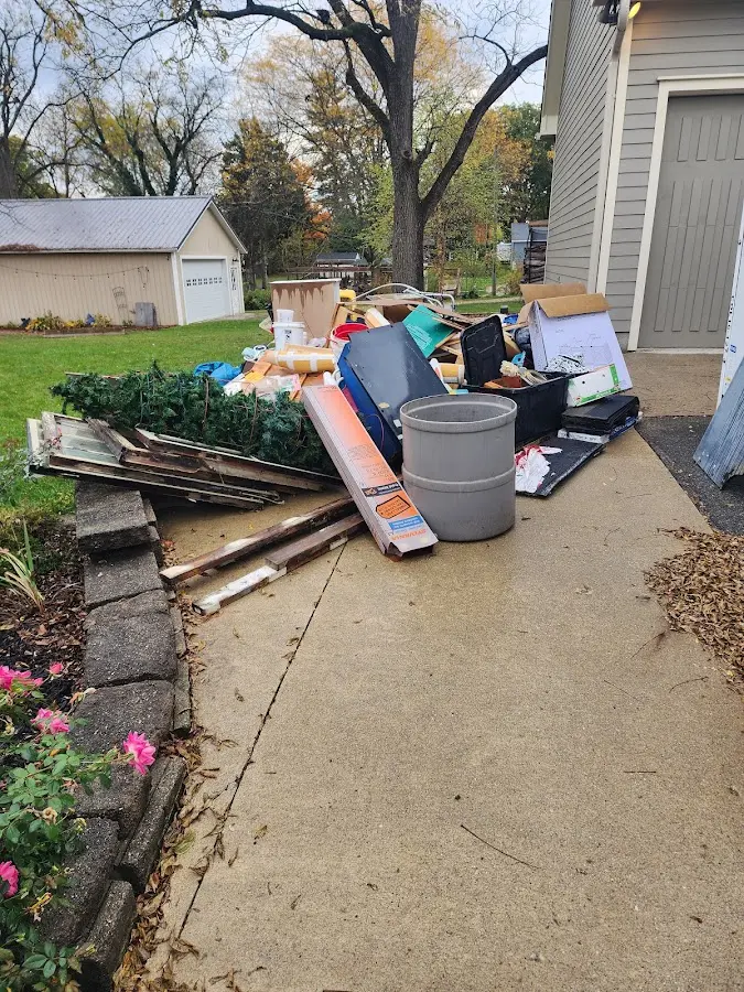 Dumpster being loaded with debris for 10 Yard Dumpster Rental in Henrietta